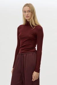 Cropped view CAMILLA AND MARC Barre High Neck Top in Burgundy with long sleeves and V‑neck split turtleneck.