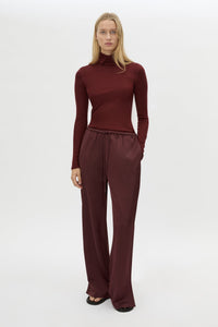 Front view CAMILLA AND MARC Barre High Neck Top in Burgundy with long sleeves and V‑neck split turtleneck.