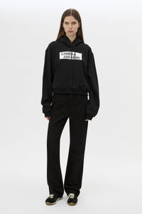 Front view CAMILLA AND MARC Carmont Graphic Hoodie in Black with boxy fit and black graphic logo.