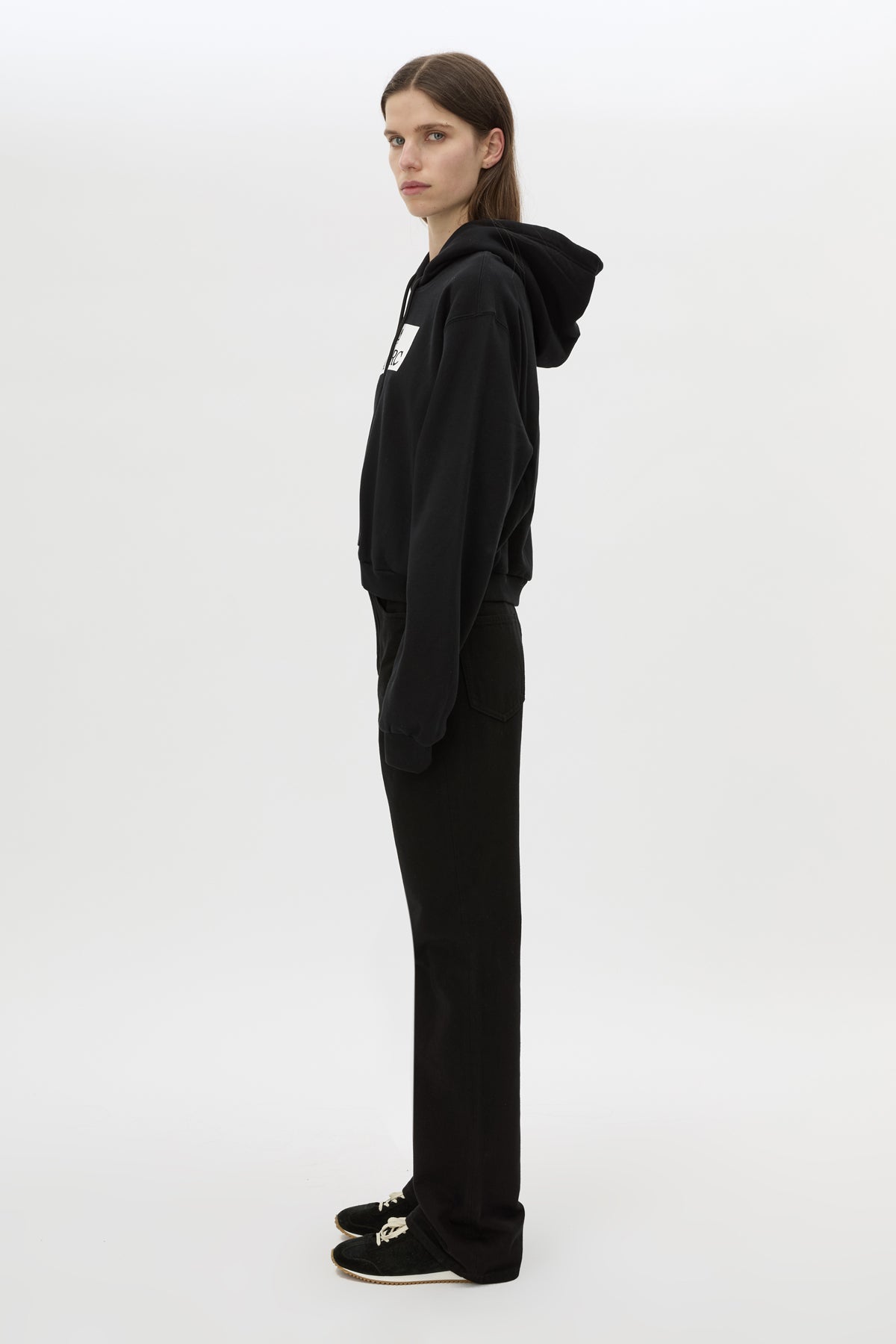 Side view CAMILLA AND MARC Carmont Graphic Hoodie in Black with boxy fit and black graphic logo.