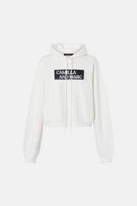 Ghost view CAMILLA AND MARC Carmont Graphic Hoodie in Soft White with boxy fit and black graphic logo.