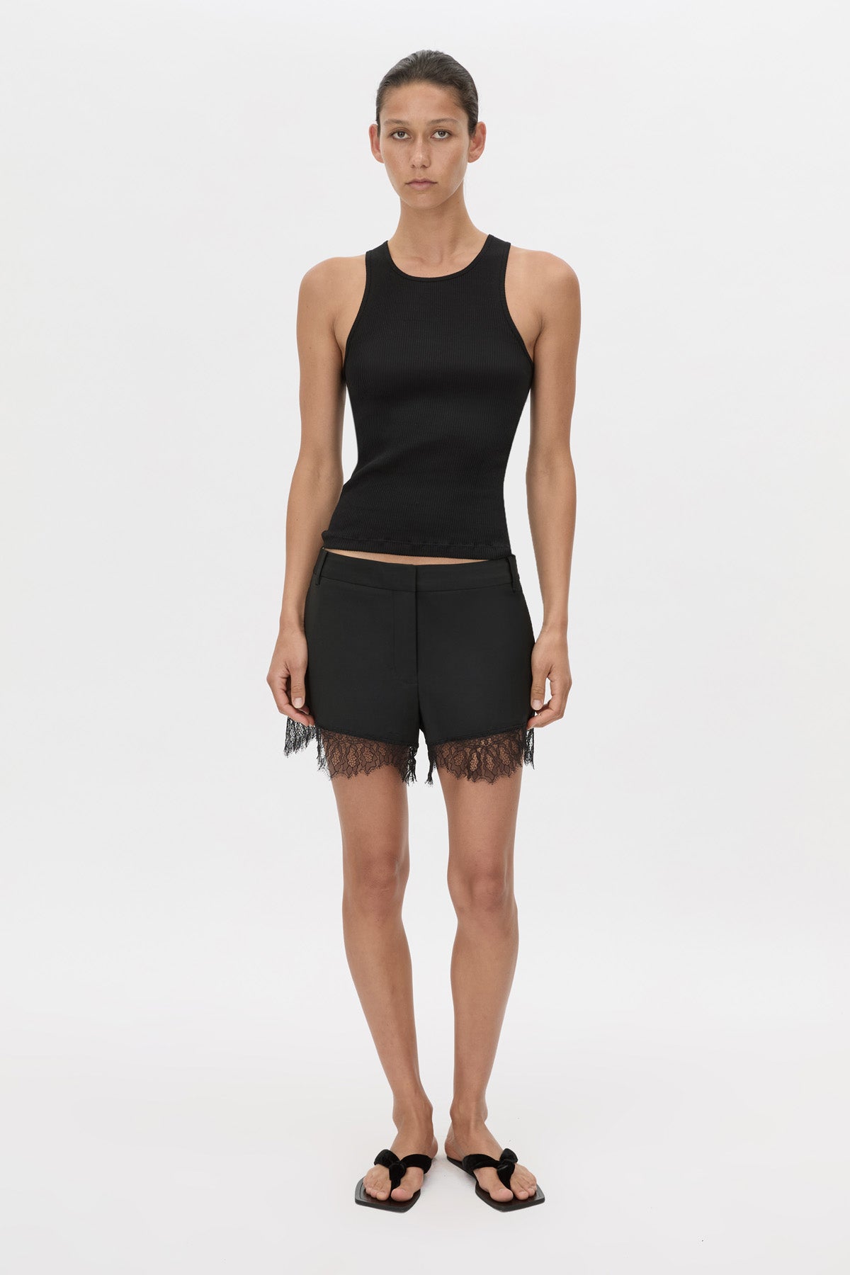 Front view CAMILLA AND MARC Chiaro Mini Short in black with lace hem detail.