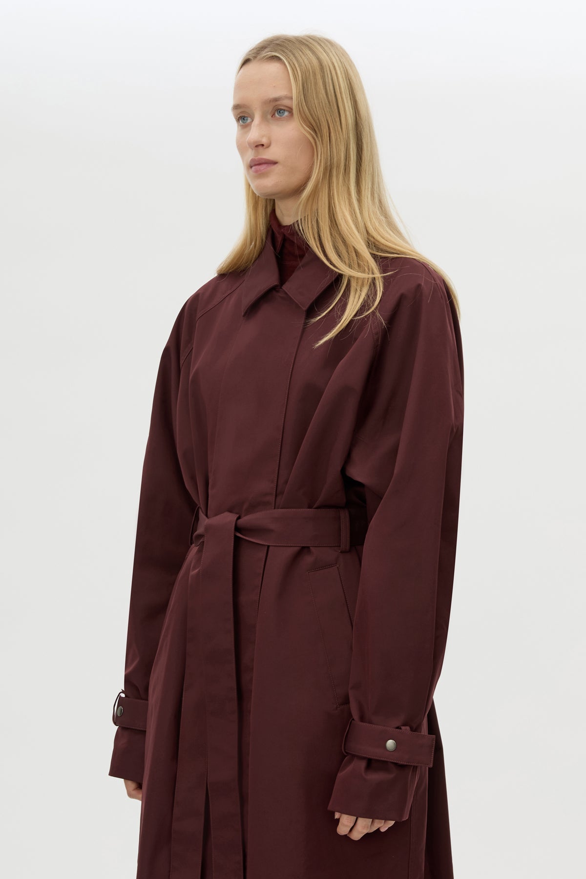 Cropped view CAMILLA AND MARC Dia Trench Coat in Burgundy with long‑line cut.