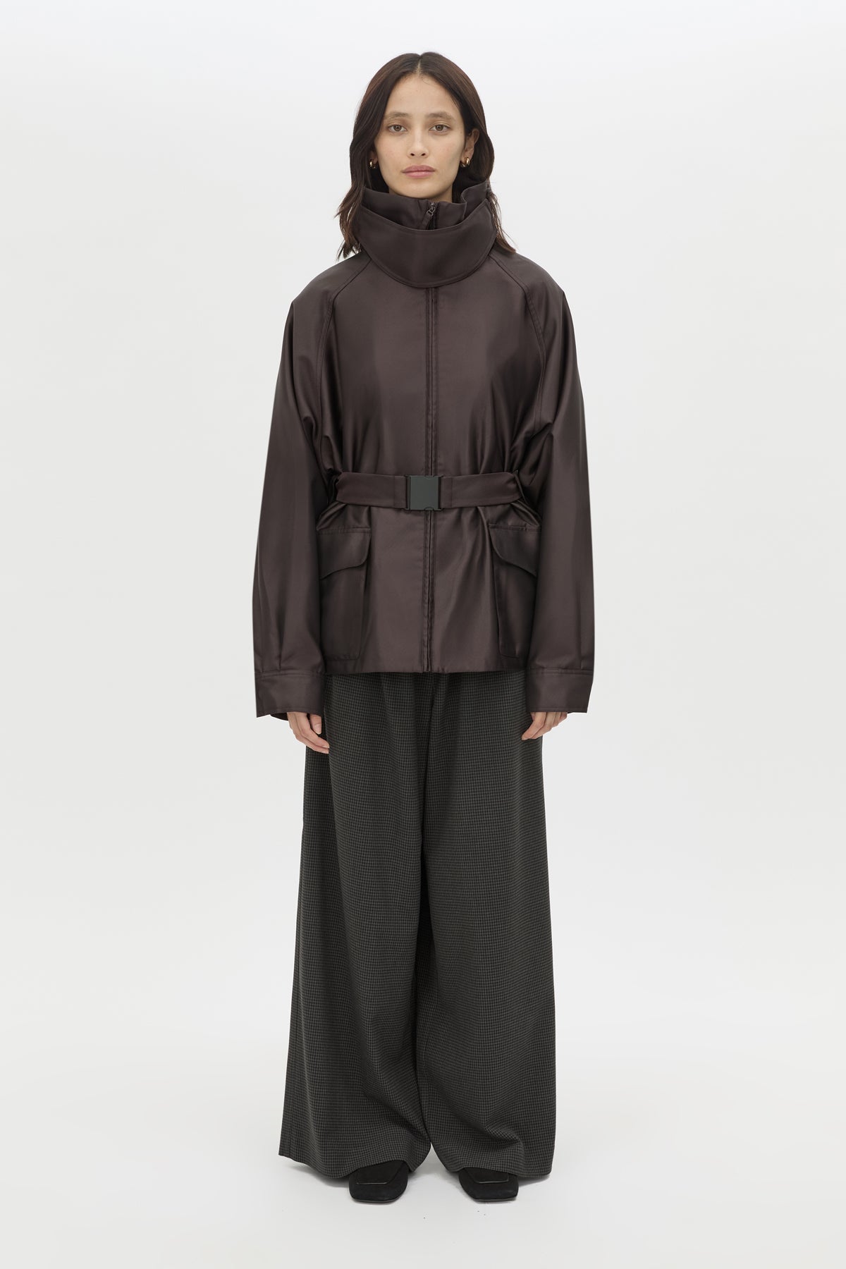 Front styled view CAMILLA AND MARC Drea Puffer Jacket in Espresso Brown with funnel neck and padded puffer silhouette.