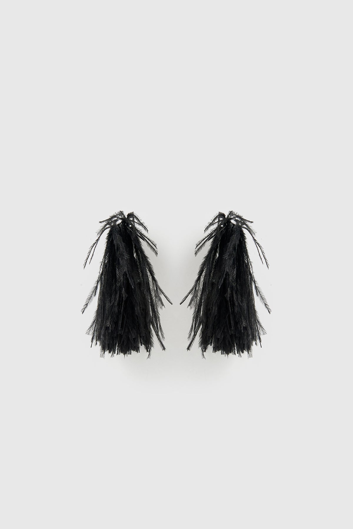 Front view CAMILLA AND MARC Friesian Feather Earrings in Black featuring sculptural soft‑spike hoops fitted with black faux ostrich feathers.