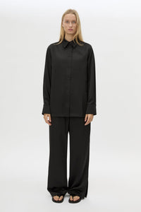 Front view CAMILLA AND MARC Ground Satin Long Sleeve Shirt in Black with collared neckline.