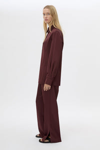 SIde view CAMILLA AND MARC Ground Satin Pant in Black with relaxed fit.