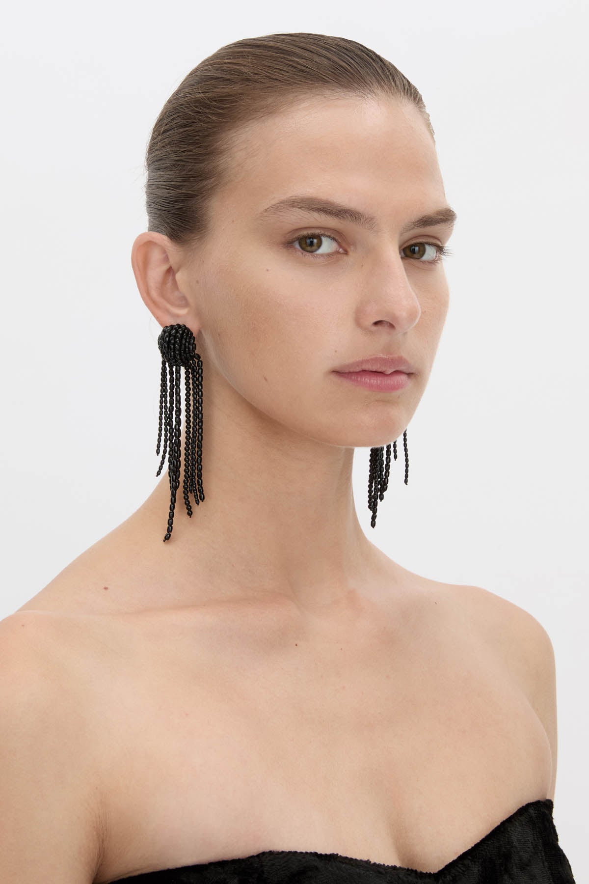 Side view CAMILLA AND MARC Irida Drop Earrings in black with glossy beaded drop design.