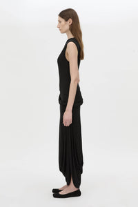 Side view CAMILLA AND MARC Myro Midi Dress in black with a fitted waistline and a twisted drape detail at the hip.