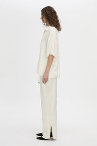 Side view CAMILLA AND MARC Naidee Satin Short Sleeve Shirt in ivory white.