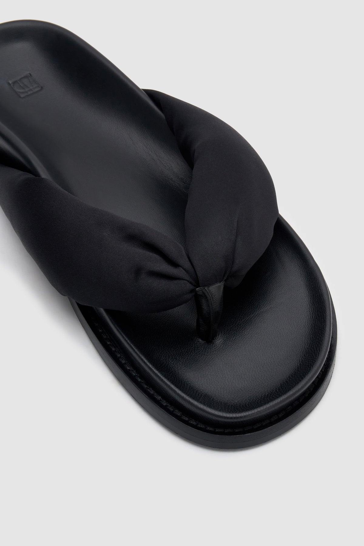 Close up view CAMILLA AND MARC Nina Slide Sandal in Black with padded satin straps.