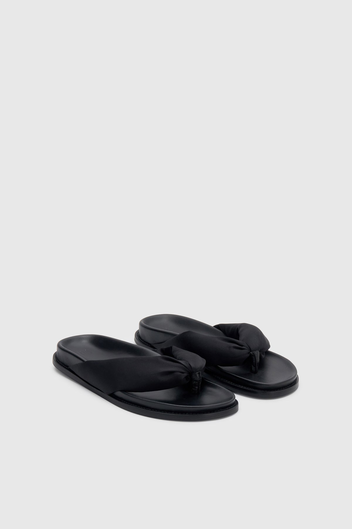 Three-quarter view CAMILLA AND MARC Nina Slide Sandal in Black with padded satin straps.