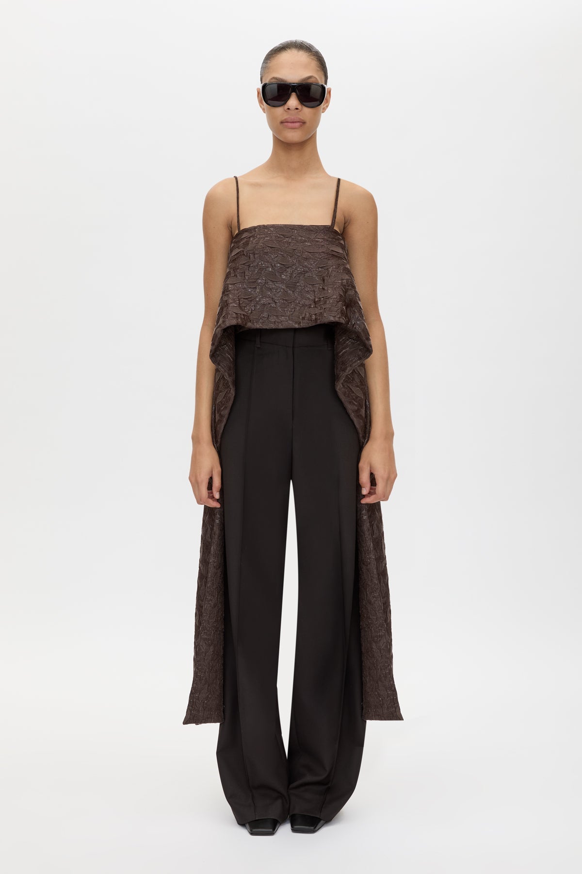 Front styled view CAMILLA AND MARC Rennick Cami Top in Chocolate with thin straps, cropped front hem and long draped back panels.