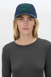 Front view CAMILLA AND MARC Sonora Embroidered Logo Cap in Deep Ink with embroidered artwork.