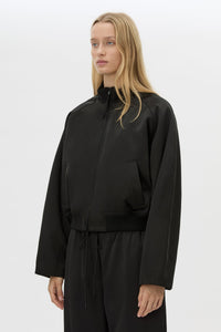 Cropped view CAMILLA AND MARC Tamar Satin Bomber Jacket in black with front zipper.
