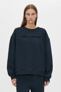 Cropped view CAMILLA AND MARC Tia Flocking Logo Crew in Deep Ink with relaxed fit, logo artwork and 100% cotton.