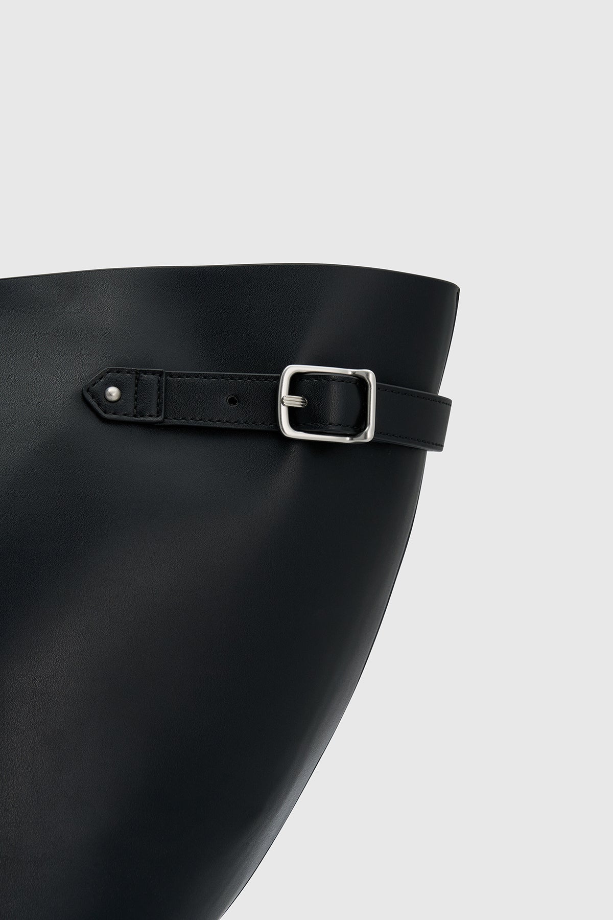 Front styled view CAMILLA AND MARC Willa Tote in Black with side strap and buckle detailing and magnetic button closure.