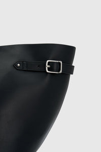 Front styled view CAMILLA AND MARC Willa Tote in Black with side strap and buckle detailing and magnetic button closure.