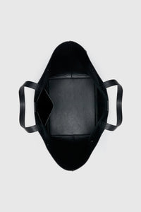 Top view CAMILLA AND MARC Willa Tote in Black with side strap and buckle detailing and magnetic button closure.
